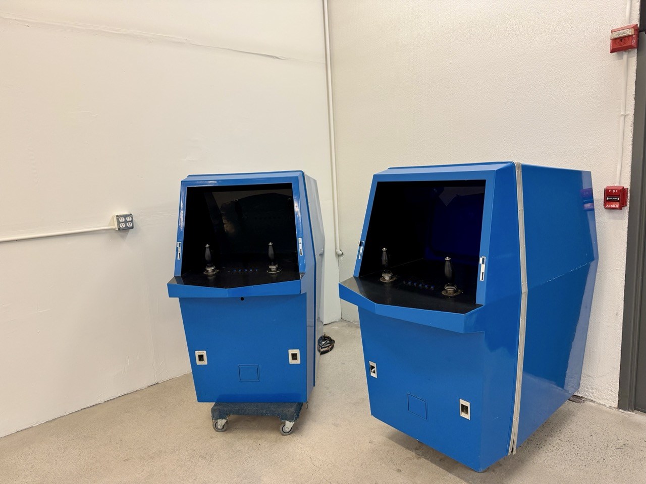 Staged view of the later blue consoles, showing front and side profiles.