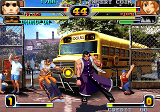 Another Rage of the Dragons match, with Elias and Pupa at the school-bus stage. This distinct preservation capture documents character and stage art; source: libretro MAME thumbnail collection, capture date unknown.